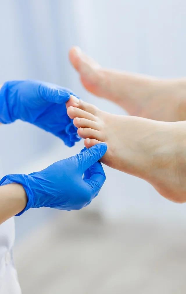 Close up shot of a foot healthcare professional examining a patient's foot