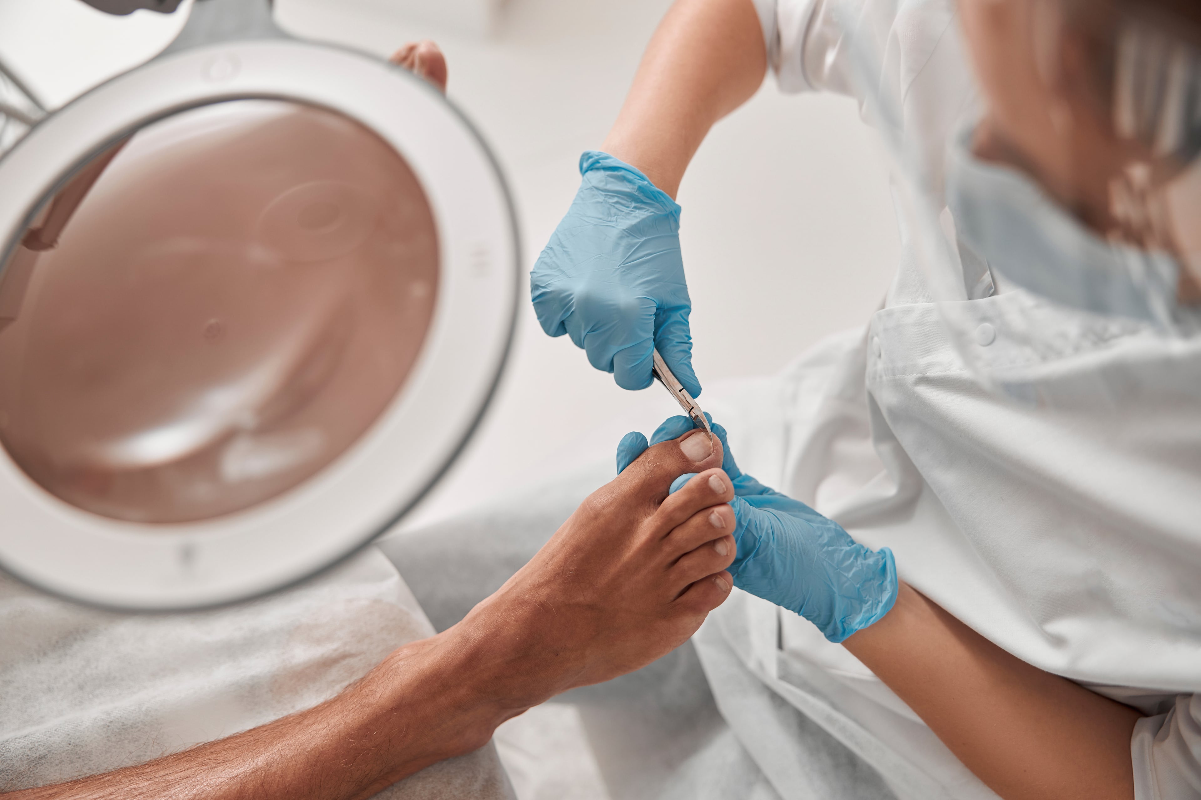 Close up shot of a foot healthcare professional trimming a patient's nails